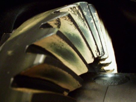1986 Ford Bronco - Close-up of a differential gear, showing wear patterns. The Supermotors.net logo is visible in the lower right corner.