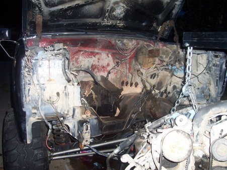 1986 Ford Bronco - The engine bay of a vehicle is shown with the hood open, indicating ongoing mechanical work.