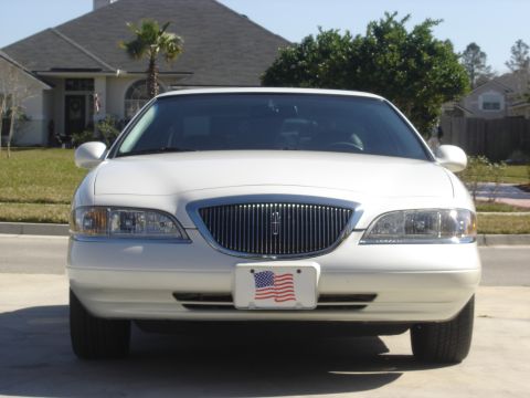 1997 Lincoln Mark VIII - The front grille and headlights of a white Lincoln Mark VIII are visible.