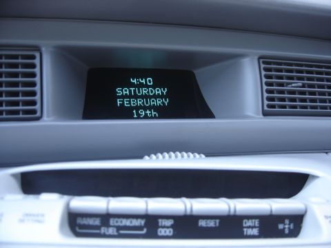 1997 Lincoln Mark VIII - Digital display shows time and date, with climate control buttons visible on the dashboard.