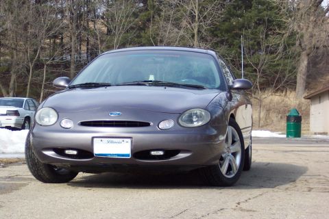 1996 Ford Taurus - Gray Ford Taurus parked outdoors with a white car visible in the background.