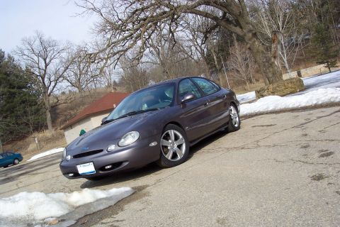 1996 Ford Taurus - This 1996 Ford Taurus is captured in a three-quarter front view, its dark gray exterior.