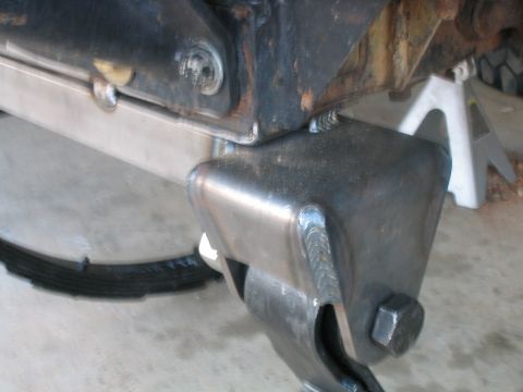 1986 Ford F-150 - Custom welded bracket attached to the rear leaf spring suspension of a truck.