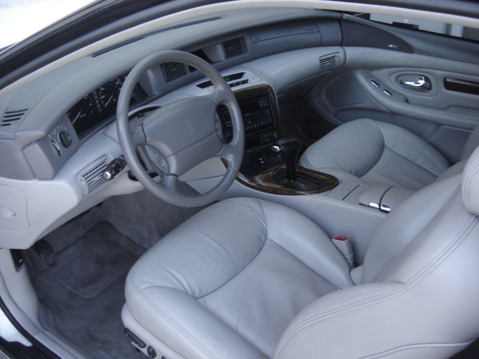 1997 Lincoln Mark VIII interior with light gray leather seats, dashboard, and steering wheel