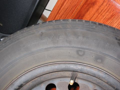 1994 Ford Probe - Close-up of a tire showing the P205/55R16 size designation on the sidewall.