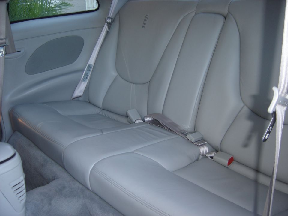 Light gray leather rear bench seat in a Lincoln coupe interior