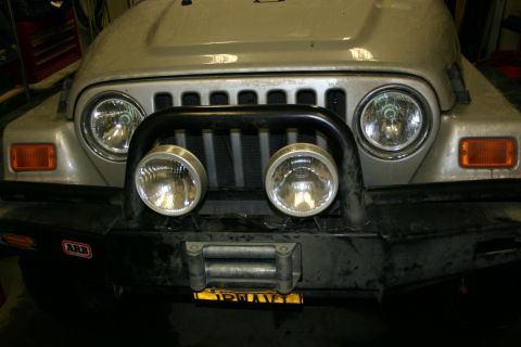 2003 Jeep TJ - Front view of a silver Jeep Wrangler an ARB bumper, winch, and auxiliary lights.