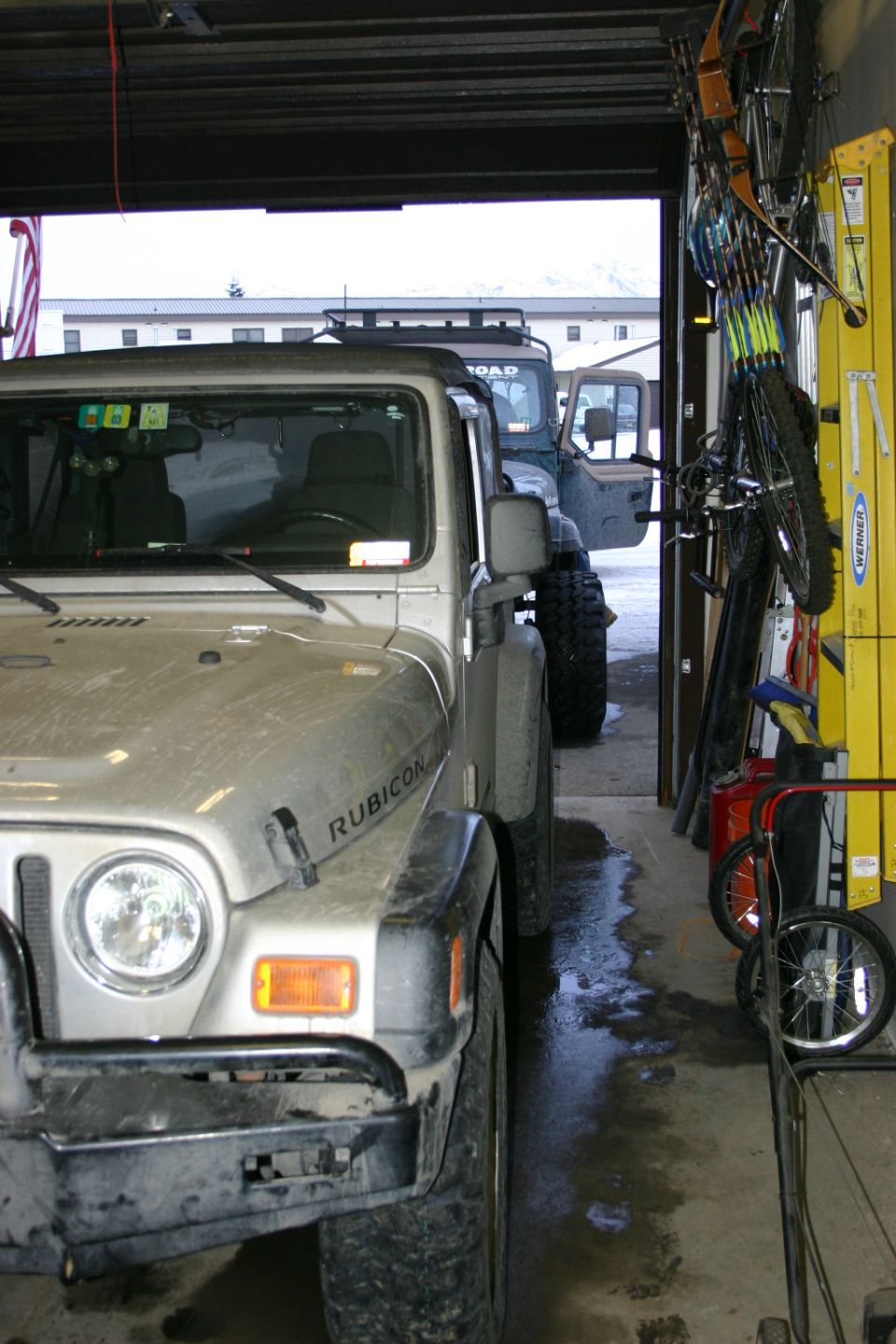 2003 Jeep TJ Rubicon parked in garage next to another Jeep