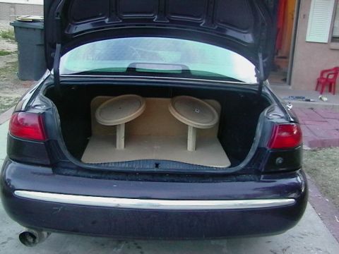 1999 Ford Taurus - Trunk of a 1999 Ford Taurus with custom wooden speaker mounts installed.