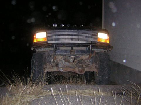 1995 Ford Bronco - This 1995 Ford Bronco is seen from the front at night, with its headlights illuminated.
