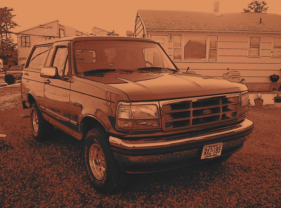 1995 Ford Bronco parked in driveway, front quarter view