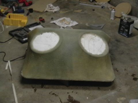 1999 Ford Taurus - Custom fiberglass enclosure with two speaker cutouts sits on a concrete floor amidst tools and materials.