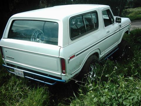 1978 Ford Bronco - This 1978 Ford Bronco is seen from the rear, navigating off-road terrain with a custom blue bumper.