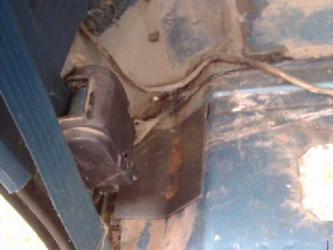 1984 Ford Bronco - floor plate for main hoop. The seatbelt assly is coming out, just left it in to show location of plate.