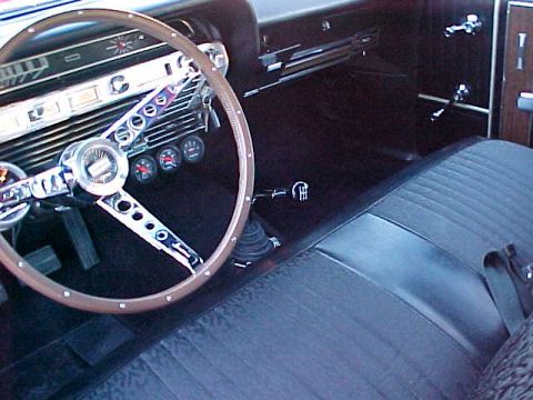 1967 Ford Galaxie - The interior of a 1967 Ford Galaxie shows a detailed dashboard and a bench seat.