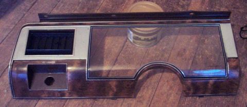 1985 Ford LTD Crown Victoria - This dashboard trim piece features a wood-grain finish and cutouts for various car components.