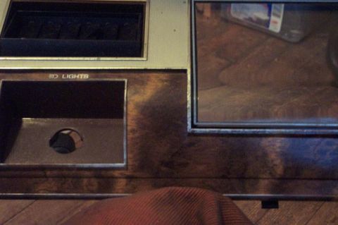 1985 Ford LTD Crown Victoria - Close-up of a car's dashboard, showing wood grain trim and a switch labeled "LIGHTS".