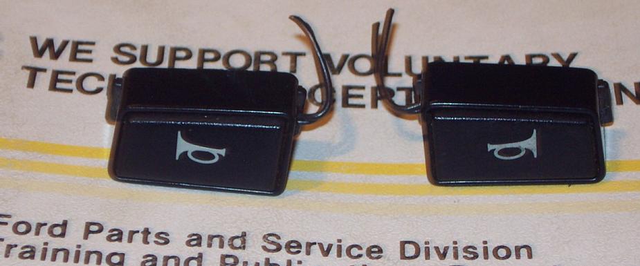 Two black horn buttons with horn icon