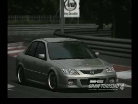 1995 Mazda 626 - This silver sedan is shown on a race track, possibly from a racing simulation game.