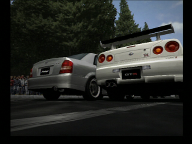 Racing game screenshot: rear view of a silver sedan next to a silver Nissan Skyline GT-R with rear wing
