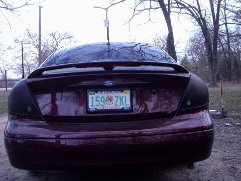 2000 Ford Taurus - Rear view of a maroon 2000 Ford Taurus sedan, a spoiler and Oklahoma license plate.