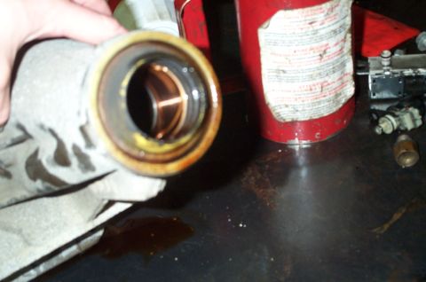1998 Ford Crown Victoria - The old tailshaft housing and it's rear bushing. This is be replaced with a bushing that is lubricated by the tapping and running of an add…