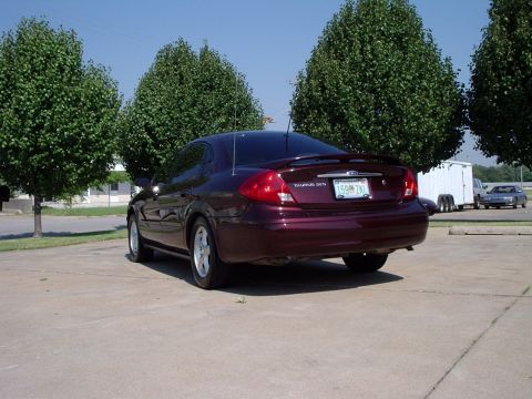 2000 Ford Taurus - Rear view of a maroon 2000 Ford Taurus sedan parked outdoors on a sunny day.