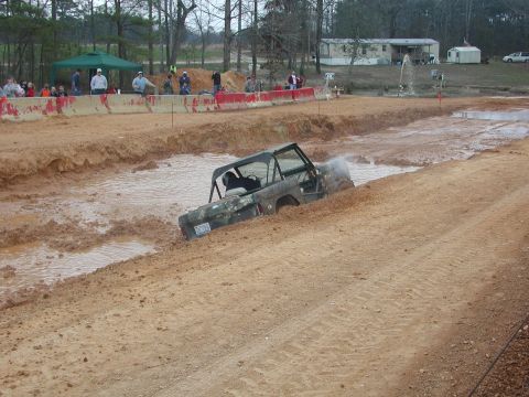 1985 Ford Bronco - A Ford Bronco, likely from the early 1980s, tackles a challenging mud course.