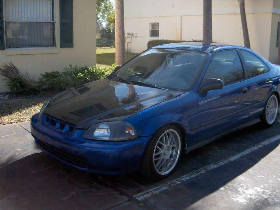 Blue Honda Civic coupe with black carbon-fiber hood and silver aftermarket wheels