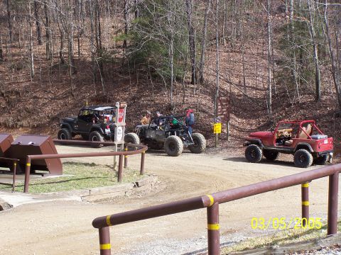 1979 Ford F-150 - Several off-road vehicles are gathered on a dirt path in a wooded area, with a date stamp of 03/05/2005.