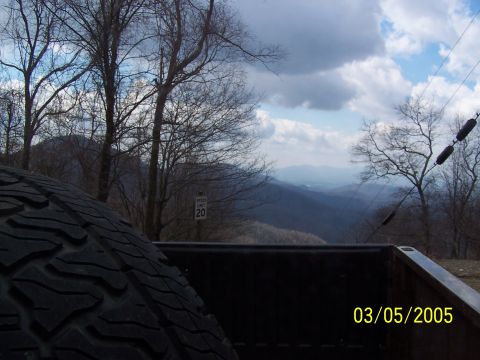 1979 Ford F-150 - View from the back of a truck, showing a mountainous landscape and a speed limit sign.