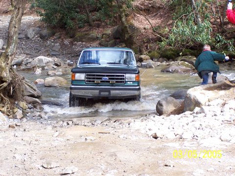 1979 Ford F-150 - Ford F-Series truck navigates a stream crossing in a wooded area. Date stamp indicates March 5, 2005.
