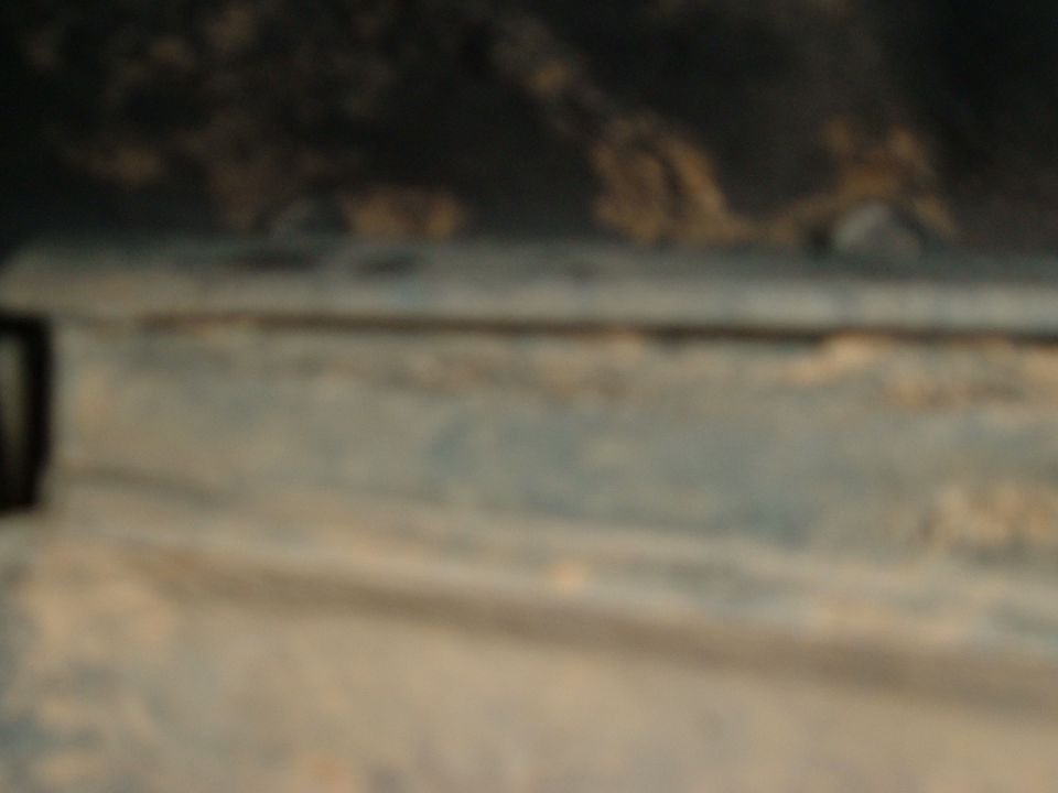 Worn blue paint on a vehicle panel with a Supermotors.net watermark
