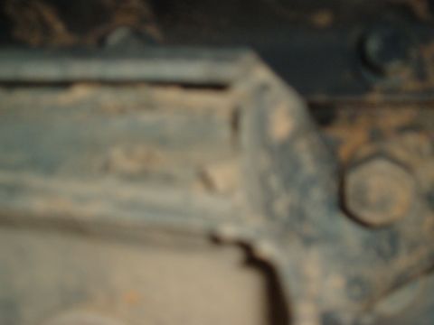1978 Ford Bronco - This image shows a close-up view of the undercarriage of a vehicle, focusing on the frame and suspension components.
