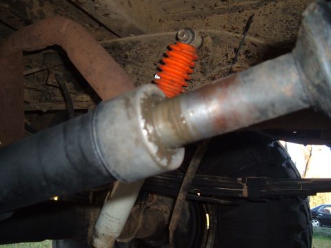 1978 Ford Bronco - Close-up view of the undercarriage components, including the exhaust system and suspension.
