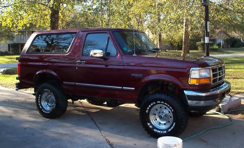 1996 Ford Bronco - This maroon 1996 Ford Bronco features a body lift and aftermarket wheels with steel radial tires.