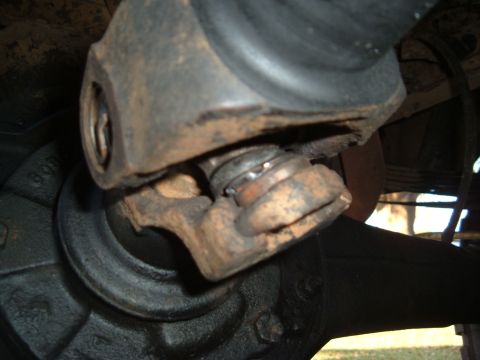 1978 Ford Bronco - Close-up view of a worn driveshaft universal joint, showing rust and damage to the bearing cap.
