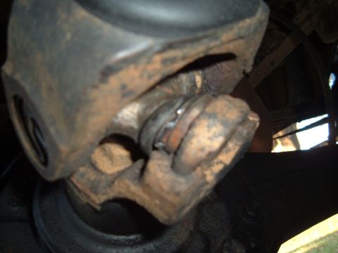 1978 Ford Bronco - Close-up of a rusty driveshaft universal joint, showing wear and tear.