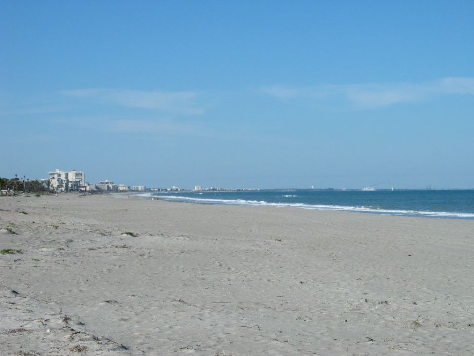 Beach with buildings in the distance and the ocean