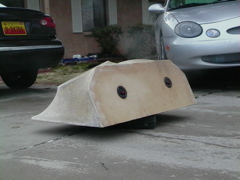 1999 Ford Taurus - A fiberglass body kit part is in the foreground, with two vehicles partially visible behind it.