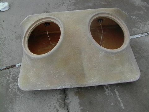 1999 Ford Taurus - This custom dual speaker enclosure features two large circular openings for speakers and visible wiring.
