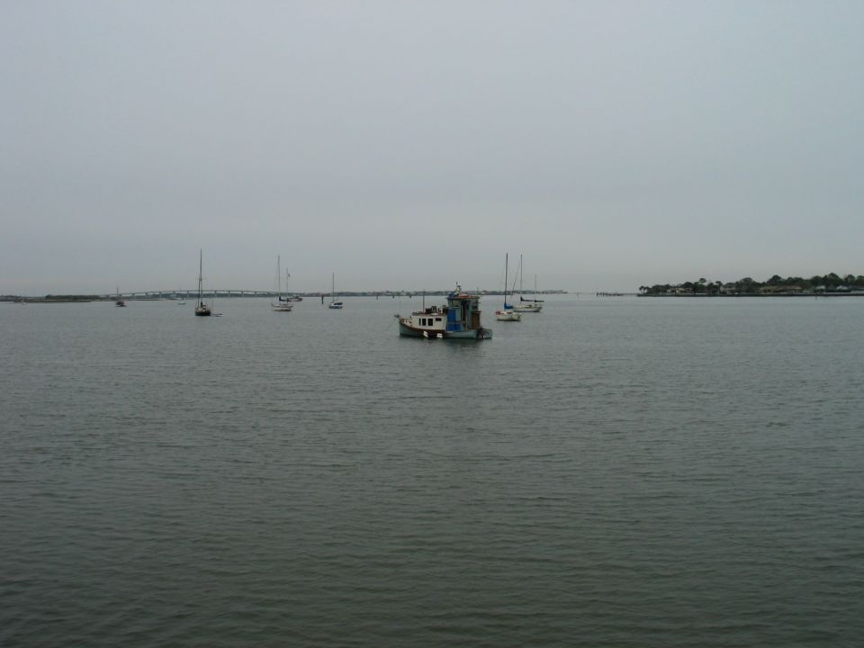 boats on the water with a tugboat in the middle distance