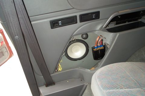 1996 Ford Bronco - Rear side-panel speaker install in progress in a gray Ford truck interior: a white-cone mid-bass driver and small dome tweeter are mounted…