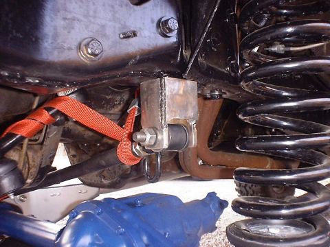 1988 Ford Bronco - Close-up view of custom suspension hardware and a blue differential on a vehicle.