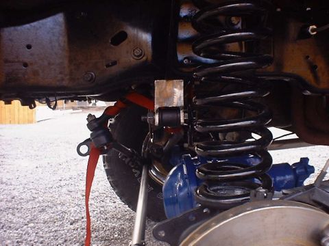 1988 Ford Bronco - This image shows the suspension system of a vehicle, focusing on the coil spring and related components.