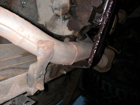 1984 Ford Bronco - Undercarriage view of a vehicle's exhaust system and mounting hardware.