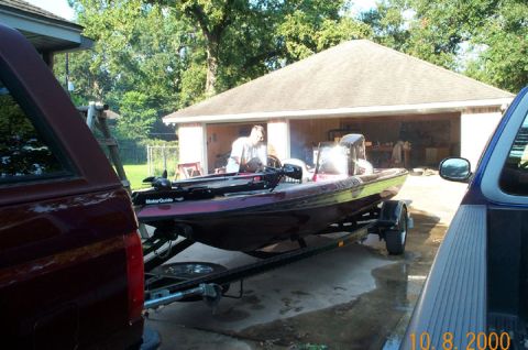 1996 Ford Bronco - Bass boat on trailer in driveway, with trucks and garage in background.
