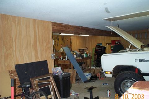 1996 Ford Bronco - White pickup truck in a garage with tools and equipment. The hood is open, revealing the engine bay.