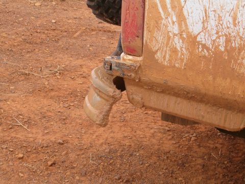 1996 Ford Bronco - This vehicle's rear bumper and tire are heavily covered in mud, suggesting off-road use.
