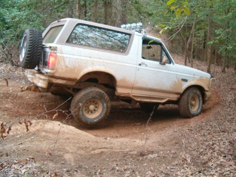 1996 Ford Bronco - This 1996 Ford Bronco navigates a challenging off-road course, kicking up dirt as it goes.